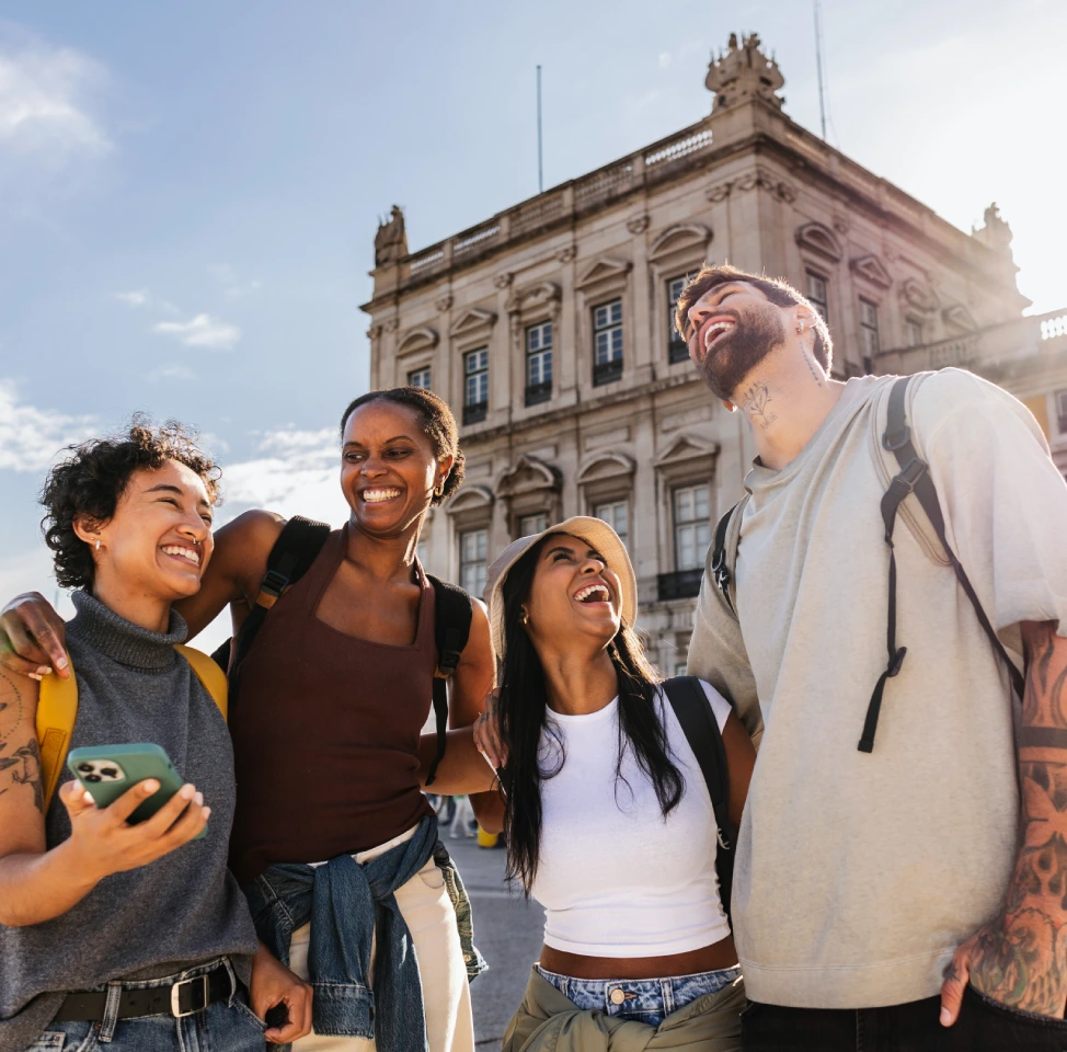 Happy tourists laughing together in Lisbon Portugal