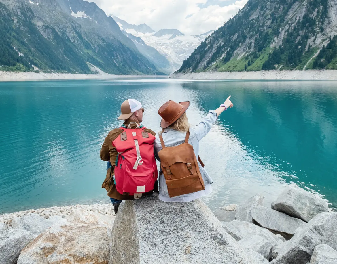 a team of travelers looking at the lake in austria